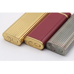 Lighters - CARTIER - Lotto di 3 accendini -corpi argentati, dorati ed u...