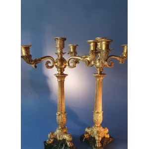 Pair of Empire candlesticks. Gilded bronze. First half of the 19th century. Slight chipping on the marble base.