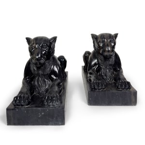 Pair of crouching lions in black marble