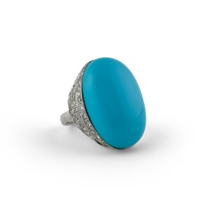 18-karat white gold ring with a large turquoise cabochon and diamonds
