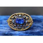 A timeless brooch with faceted emerald-colored glass stones—Vintage from the 1970s