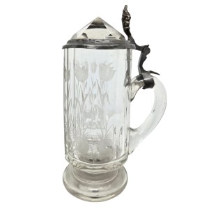 A glass mug with a floral design and a crystal-cut lid