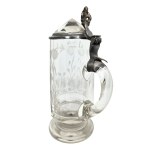 A glass mug with a floral design and a crystal-cut lid