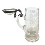 A glass mug with a floral design and a crystal-cut lid