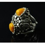 A massive ring with amber stones, marked P.J. (151)