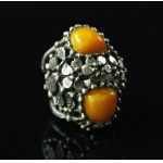 A massive ring with amber stones, marked P.J. (151)