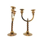 A pair of brass candlesticks on a spiral base