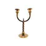 A pair of brass candlesticks on a spiral base