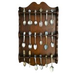 A set of collectible teaspoons in a wooden display case