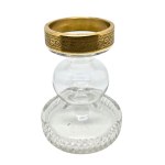 Vintage candlestick made of faceted glass with a gold rim