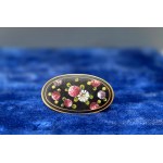 An old, hand-painted brooch with brass settings—1930s