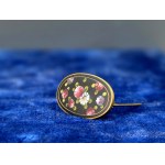 An old, hand-painted brooch with brass settings—1930s
