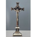 An old nickel-plated crucifix with a figure of Jesus on an ornate base—France, first half of the 20th century