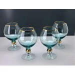 A set of four ZŁOTA ZUZANNA cognac glasses in turquoise blue