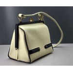 Retro cream-colored satchel-style handbag with black accents—1960s