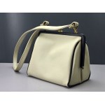 Retro cream-colored satchel-style handbag with black accents—1960s
