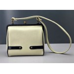 Retro cream-colored satchel-style handbag with black accents—1960s