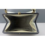 Retro cream-colored satchel-style handbag with black accents—1960s