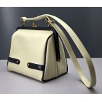 Retro cream-colored satchel-style handbag with black accents—1960s