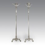 Pair of nickel-plated bronze candlesticks, with fluted shafts on a shaped base and feet ending in cleats