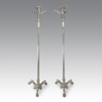 Pair of nickel-plated bronze candlesticks, with fluted shafts on a shaped base and feet ending in cleats