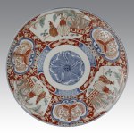 Pair of large Chinese Imari plates with floral motifs and anthropomorphic figures