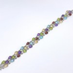 A three-row silver bracelet with natural topaz, peridot, garnet, amethyst, and citrine