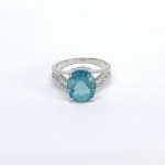 Silver ring with a natural green topaz and white sapphires