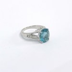 Silver ring with a natural green topaz and white sapphires