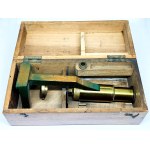 Antique travel microscope with a spare lens in a box
