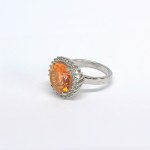 Silver ring with a natural Padparadscha topaz and white topazes