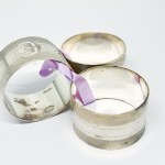 Three silver-plated napkin holders
