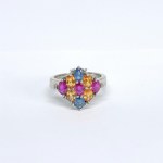 Silver ring with natural blue and orange sapphires, rubies, and diamonds