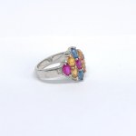 Silver ring with natural blue and orange sapphires, rubies, and diamonds