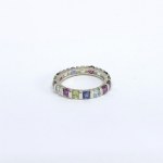 Silver eternity ring with natural peridots, iolites, garnets, and topazes