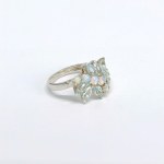 Silver ring with natural opals and topazes