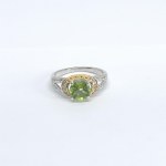 Silver ring with a green tourmaline and white topazes