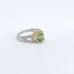 Silver ring with a green tourmaline and white topazes