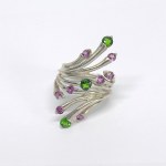 Large silver ring with green and pink garnets