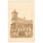 Highlanders against the backdrop of a church