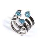 Gold ring with black diamonds and blue topazes