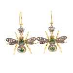 A pair of insect-shaped earrings in silver, set with emeralds and diamonds