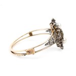 A rigid gold and silver hoop bracelet set with emerald, pearl and diamonds