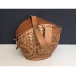 Vintage-style hand-woven wicker bag with a leather flap and handle—1970s
