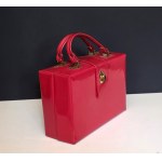 Red patent leather retro-style handbag/satchel with gold accents—1970s