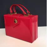 Red patent leather retro-style handbag/satchel with gold accents—1970s