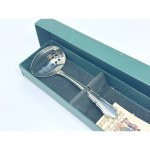 A spoon for serving vegetables, marinades, and other dishes with sauces. Comes with the original box and a certificate