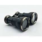 A vintage Le Sportsman binocular with a compass