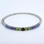 Silver bangle bracelet with natural iolites, amethysts, peridots, and garnets