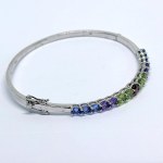 Silver bangle bracelet with natural iolites, amethysts, peridots, and garnets
